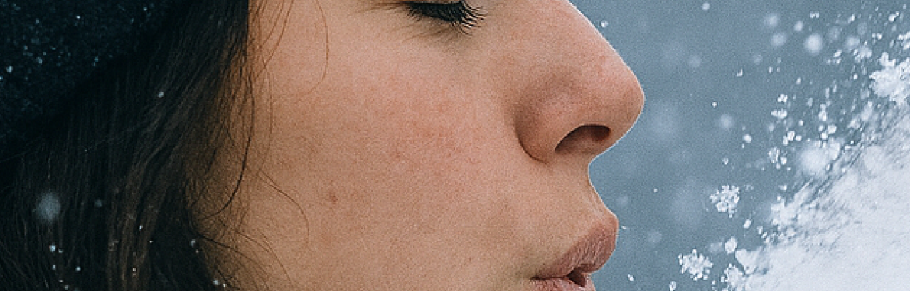 Woman blowing snow