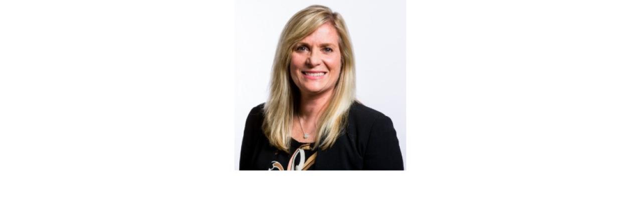 Color photo of Deborah Crown, a middle aged white woman with long blonde hair wearing a black top