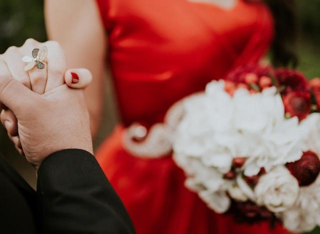 red dress flowers couple holding hands