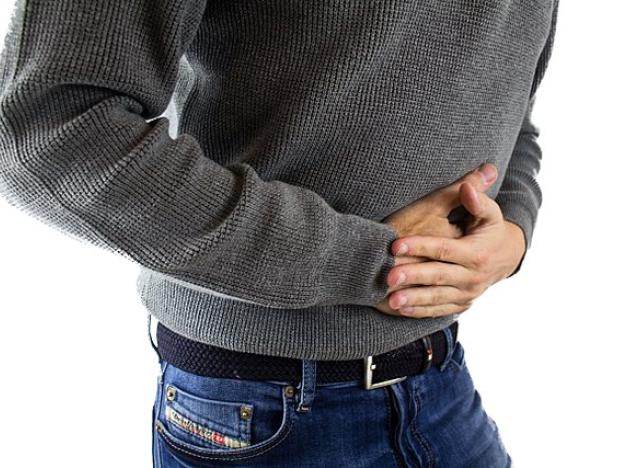 Man holding mid section